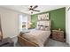 Comfortable bedroom featuring neutral walls, a ceiling fan, and an exterior view at 9588 Vital Crest St, Las Vegas, NV 89123