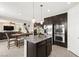 Open concept kitchen with stainless steel appliances, a central island, and a view of the living area at 9588 Vital Crest St, Las Vegas, NV 89123