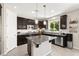 Modern kitchen with stainless steel appliances, granite countertops and tiled floors at 9588 Vital Crest St, Las Vegas, NV 89123