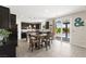 This kitchen features dark cabinets, stainless steel appliances, a central island, and seamless access to the backyard pool at 9588 Vital Crest St, Las Vegas, NV 89123
