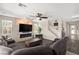 A spacious living room features a gray sofa, modern electric fireplace, and staircase at 9588 Vital Crest St, Las Vegas, NV 89123