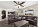 Bright living room with a gray sofa, wooden coffee table, and a clear view into the kitchen area at 9588 Vital Crest St, Las Vegas, NV 89123