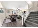 Open-concept living room features a gray sofa, ceiling fan and a staircase to the upper level at 9588 Vital Crest St, Las Vegas, NV 89123