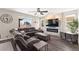 This living room boasts a gray sofa, ceiling fan, and a modern electric fireplace set in white stone at 9588 Vital Crest St, Las Vegas, NV 89123