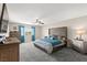 Spacious main bedroom with a king bed, ceiling fan, and plenty of natural light at 9588 Vital Crest St, Las Vegas, NV 89123