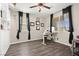 Home office with built-in shelving, ample natural light, and dark wood flooring at 9588 Vital Crest St, Las Vegas, NV 89123