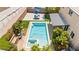 Backyard pool and patio area boasts a modern pergola, an umbrella covered lounge, and lush landscaping at 9588 Vital Crest St, Las Vegas, NV 89123
