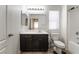 Bright bathroom featuring a dark vanity, tub with shower, and window with blinds at 9636 Salford Isle St, Las Vegas, NV 89123