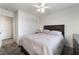 Bedroom featuring neutral tones, carpet, ceiling fan, and a sliding closet door at 9636 Salford Isle St, Las Vegas, NV 89123