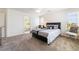 Well-lit bedroom featuring an ensuite bathroom, a bed with stylish linens, and large windows at 9636 Salford Isle St, Las Vegas, NV 89123