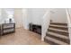 Inviting entryway with staircase, storage console, and tile floors at 9636 Salford Isle St, Las Vegas, NV 89123