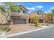 View of a two-story home featuring a two-car garage with a brick paver driveway at 9636 Salford Isle St, Las Vegas, NV 89123