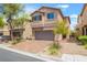 View of home with paver driveway, desert landscaping and a two-car garage at 9636 Salford Isle St, Las Vegas, NV 89123