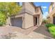 Close up of a home with a paver driveway and an attached two-car garage at 9636 Salford Isle St, Las Vegas, NV 89123