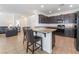 Open kitchen boasts granite counters, stainless steel appliances and dark wood cabinetry at 9636 Salford Isle St, Las Vegas, NV 89123