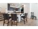 Open kitchen boasts granite counters, stainless steel appliances, and dark wood cabinetry at 9636 Salford Isle St, Las Vegas, NV 89123