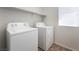 Laundry room with a washer, dryer, shelf and a window at 9636 Salford Isle St, Las Vegas, NV 89123