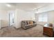 Cozy living room with a neutral color palette, plush carpeting, and plenty of natural light at 9636 Salford Isle St, Las Vegas, NV 89123