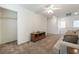 Inviting living room featuring a closet, a ceiling fan, and a classic wood media console at 9636 Salford Isle St, Las Vegas, NV 89123