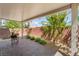 Relaxing covered patio with brick pavers, seating, and view of the landscaped backyard at 9636 Salford Isle St, Las Vegas, NV 89123