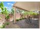 Serene covered patio with lush landscaping and brick pavers at 9636 Salford Isle St, Las Vegas, NV 89123