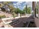 Spacious backyard featuring a stone patio, garden beds, and a retaining wall for added privacy at 1709 Pacific Panorama Pl, Las Vegas, NV 89144