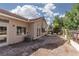 Exterior view of a stucco home with a stone patio and a desert landscaped backyard at 1709 Pacific Panorama Pl, Las Vegas, NV 89144