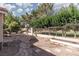 Backyard featuring a custom stone patio, garden beds, and desert landscaping at 1709 Pacific Panorama Pl, Las Vegas, NV 89144