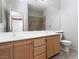 Bright bathroom featuring a double sink vanity, large mirror, tiled floors, and shower/tub combo at 1709 Pacific Panorama Pl, Las Vegas, NV 89144