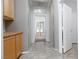 Hallway with tile flooring, wood cabinets and doors leading to other rooms at 1709 Pacific Panorama Pl, Las Vegas, NV 89144