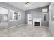 Bright living room with tile flooring, fireplace, built-in shelving, and large windows at 1709 Pacific Panorama Pl, Las Vegas, NV 89144