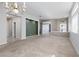 Bright living room with neutral carpet, multiple windows, and decorative lighting fixtures at 1709 Pacific Panorama Pl, Las Vegas, NV 89144