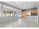 Open living space featuring tile floors, bright windows, and a cozy kitchen with ample cabinets at 1709 Pacific Panorama Pl, Las Vegas, NV 89144