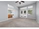 Spacious main bedroom with carpet, ceiling fan, and doors to the backyard at 1709 Pacific Panorama Pl, Las Vegas, NV 89144