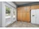 Pantry area with tile floors, storage cabinets, and door leading to the backyard at 1709 Pacific Panorama Pl, Las Vegas, NV 89144