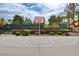 A basketball court featuring a bright red hoop and manicured landscaping at 2338 Dolphin Ct, Henderson, NV 89074