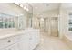 Bright bathroom with marble countertops, dual sinks, and a large mirror at 2338 Dolphin Ct, Henderson, NV 89074