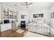 Sunlit bedroom with built-in shelving and desk, hardwood floors, and comfortable seating area at 2338 Dolphin Ct, Henderson, NV 89074