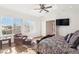 Well-lit bedroom featuring hardwood floors, sitting area, and ceiling fan at 2338 Dolphin Ct, Henderson, NV 89074