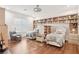 Bedroom featuring dual beds, built-in bookshelves, hardwood floors, and a comfortable reading area at 2338 Dolphin Ct, Henderson, NV 89074