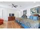 Spacious bedroom featuring hardwood floors, ceiling fan, and dual beds with blue accents at 2338 Dolphin Ct, Henderson, NV 89074