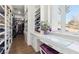 Walk-in closet featuring custom shelves, drawers, and a vanity area with a window at 2338 Dolphin Ct, Henderson, NV 89074