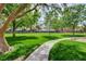 Scenic community park featuring green grass, a walking path, mature trees and a park bench at 2338 Dolphin Ct, Henderson, NV 89074