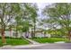 Elegant home exterior with a manicured lawn, large shade trees, and manicured landscaping at 2338 Dolphin Ct, Henderson, NV 89074