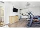 Home gym featuring a treadmill, stationary bike, television, and built in shelving at 2338 Dolphin Ct, Henderson, NV 89074