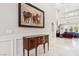Bright hallway with marble floors and artwork, leading to living areas with comfortable seating and natural light at 2338 Dolphin Ct, Henderson, NV 89074