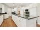 Spacious kitchen features white cabinets, granite countertops, and modern appliances at 2338 Dolphin Ct, Henderson, NV 89074