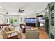 Spacious living room featuring a fireplace, a large aquarium, and a billiards table, perfect for entertainment and relaxation at 2338 Dolphin Ct, Henderson, NV 89074