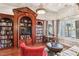 Living room features custom built-in bookshelves and large windows at 2338 Dolphin Ct, Henderson, NV 89074