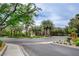 Neighborhood street view with mature trees and lush greenery on a sunny day at 2338 Dolphin Ct, Henderson, NV 89074